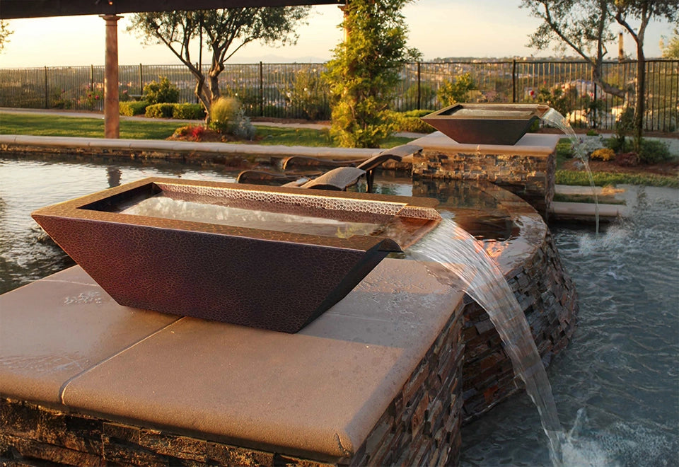 Elegant modern copper water bowl with scalloped edge design, showcasing a smooth water flow feature, ideal for enhancing outdoor landscapes and garden aesthetics.