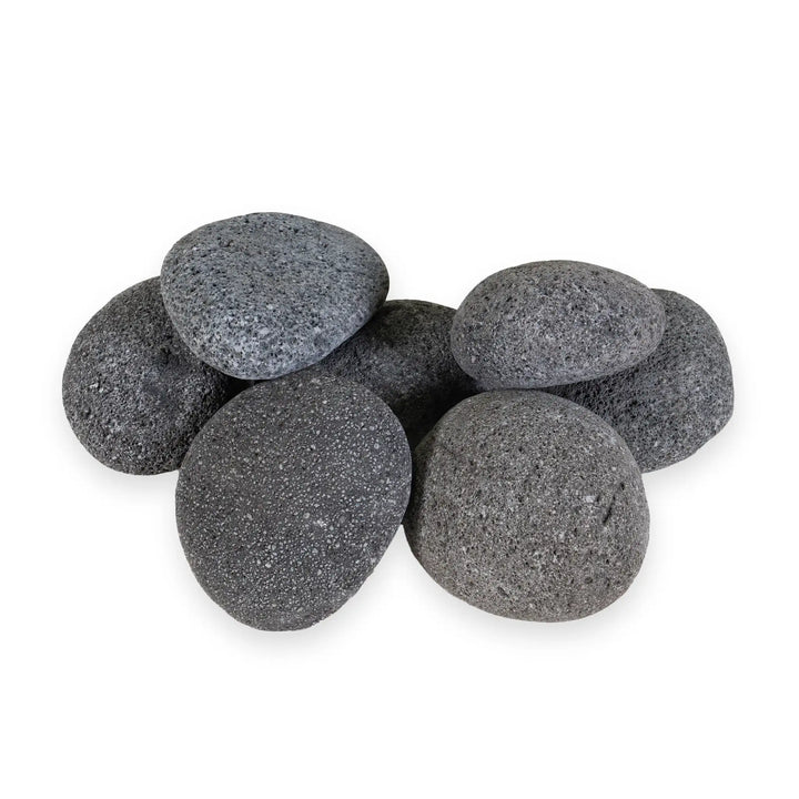 A pile of large Starfire Designs 3-5 inch outdoor rolled lava rocks, highlighting their natural porous texture and robust heat retention properties. These volcanic stones are ideal for outdoor fire pits, providing an authentic and durable fire feature material.