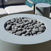 Starfire Designs outdoor rolled lava rocks displayed in a modern round fire pit by the poolside. These naturally formed lava rocks, ranging from 1 to 5 inches, are perfect for contemporary outdoor designs, offering both aesthetic beauty and excellent heat retention for fire features