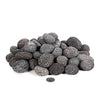 A pile of medium-sized (2-3 inches) outdoor rolled lava rocks, perfect for use in fire pits and fireplaces. These volcanic rocks feature a porous surface, ideal for trapping heat and distributing it evenly. Their natural color and texture create a rustic, authentic look for any outdoor fire feature. A coin is placed for size comparison