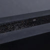 A focused close-up of extra small black volcanic lava rocks resting inside a fire pit. Their distinct porous surface gives them a natural aesthetic, perfect for outdoor and indoor fire features. The durable volcanic material is ideal for high-heat environments, adding both function and style to any fire setup.