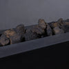 A detailed close-up of large volcanic lava rocks placed in a fire pit, showing their unique texture and natural formation. The dark lava stones are heat-resistant and ideal for fire pit use. Their porous surfaces provide optimal air circulation, making them not only visually appealing but also functional for fire pit setups. The large size of these rocks adds a substantial, natural look to any outdoor fire feature