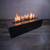 Medium volcanic lava rock in a fire pit with bright flames. These 2-3 inch porous volcanic stones are ideal for outdoor fire pits, providing superior heat retention and a natural look. Great for enhancing the aesthetic appeal of any modern outdoor space