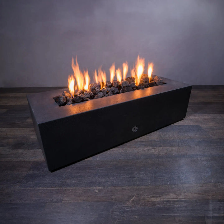 Medium volcanic lava rock in a fire pit with bright flames. These 2-3 inch porous volcanic stones are ideal for outdoor fire pits, providing superior heat retention and a natural look. Great for enhancing the aesthetic appeal of any modern outdoor space