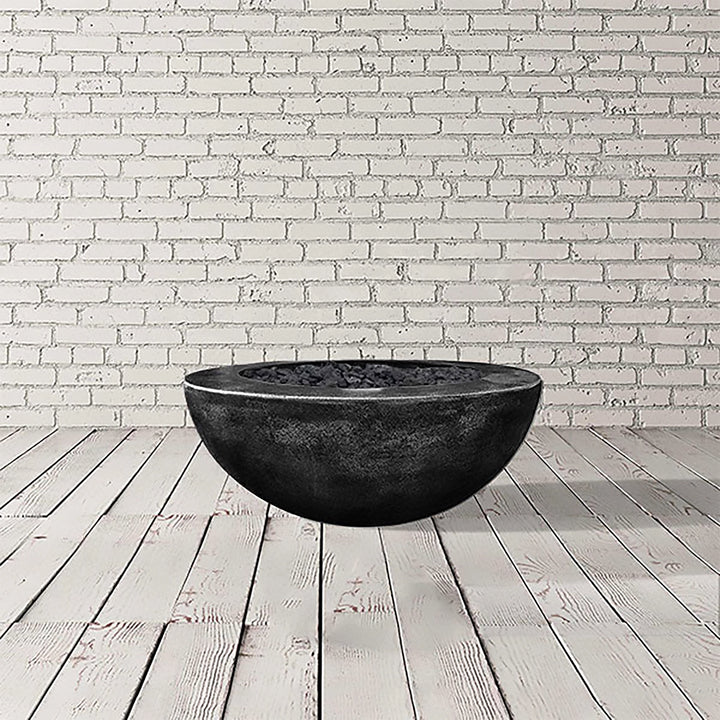 Prism Hardscapes Moderno 5 Gas Fire Pit in Ebony, featuring a bold black round concrete bowl. This modern fire pit offers a contemporary outdoor heating solution for both natural gas and propane options. Perfect for creating a focal point in your patio or backyard, this fire pit is crafted for longevity, making it an ideal choice for outdoor gas fire pits and commercial settings.