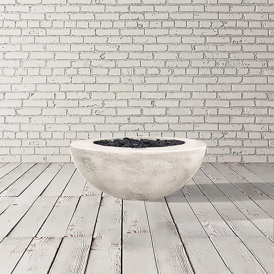 Prism Hardscapes Moderno 5 Gas Fire Pit in Natural Gray, presenting a light gray round concrete fire bowl. This outdoor fire pit delivers style and functionality, designed for both natural gas and propane fuel types. It's perfect for enhancing outdoor spaces with a modern touch while providing warmth and atmosphere. A great addition to patios and gardens, this fire pit is built for durability and outdoor enjoyment.