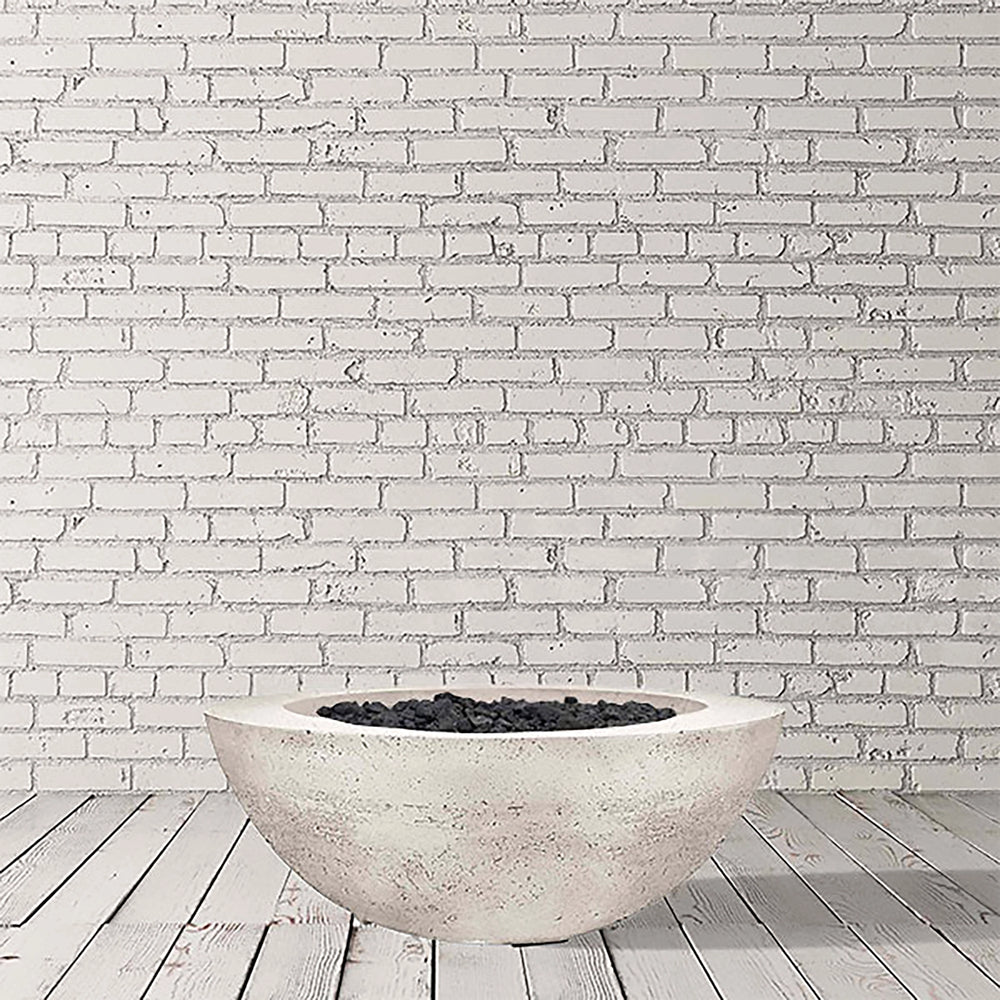 Prism Hardscapes Moderno 6 Gas Fire Bowl in pewter, presented in a studio environment with a light wooden floor. This durable round gas fire pit is designed for use in large outdoor spaces and features a contemporary style perfect for modern patio fire pit designs.