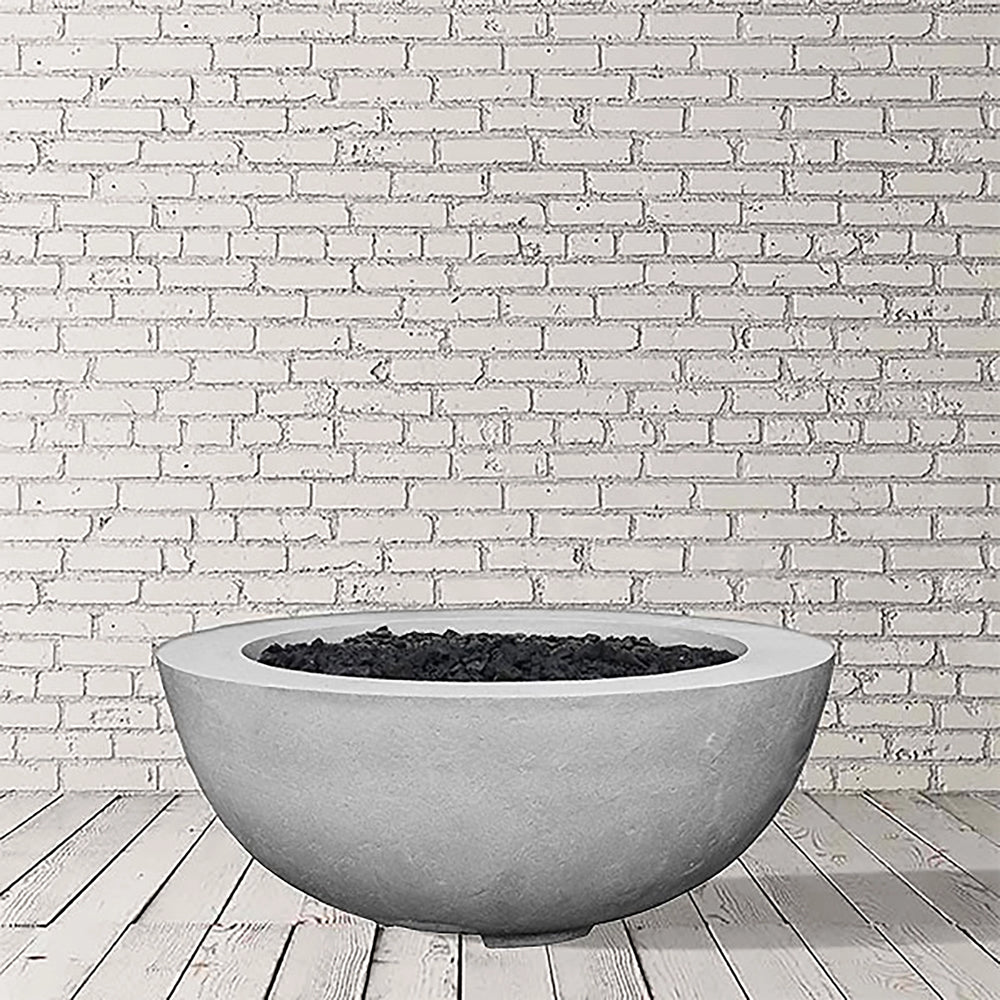 Prism Hardscapes Moderno 8 Gas Fire Bowl in Natural Gray finish, showcasing a textured concrete surface with a smooth, minimalist design. This round gas fire bowl fits seamlessly into any outdoor patio or backyard area, perfect for both propane and natural gas configurations. A modern outdoor fire pit ideal for creating a warm and inviting atmosphere.