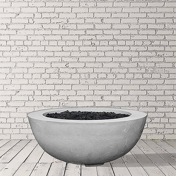 Prism Hardscapes Moderno 8 Gas Fire Bowl in Natural Gray finish, showcasing a textured concrete surface with a smooth, minimalist design. This round gas fire bowl fits seamlessly into any outdoor patio or backyard area, perfect for both propane and natural gas configurations. A modern outdoor fire pit ideal for creating a warm and inviting atmosphere.