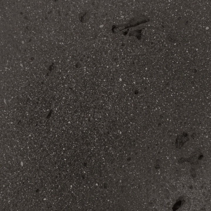 Close-up swatch of the ebony color concrete texture from the Prism Hardscapes Ovale Gas Fire Pit. This deep, dark shade provides a sleek, contemporary look, perfect for modern fire pits, luxury outdoor spaces, and large backyard fire pits