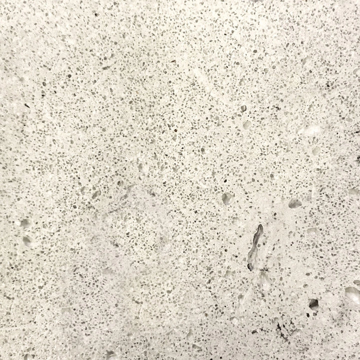 Detailed swatch of the natural gray concrete texture from the Prism Hardscapes Ovale Gas Fire Pit. The raw, textured surface offers a natural and organic feel, ideal for rustic and modern backyard fire pits, outdoor gas fire pits, and patio fire tables