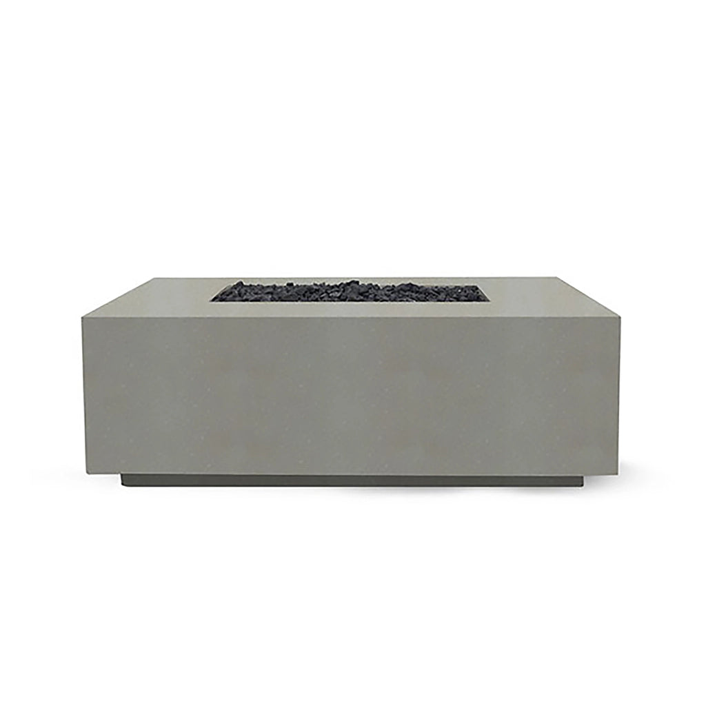 Showcased here is the Prism Hardscapes Portos 58" Propane Fire Table in natural finish, blending seamlessly into a lush outdoor scene. The natural beige hue adds warmth and elegance to any patio or backyard setup, making it ideal for a fire pit outdoor gas installation. This durable fire table combines practicality with beauty, featuring a large burner area filled with black lava rock. Perfect for backyard fire pit lovers who appreciate natural tones.