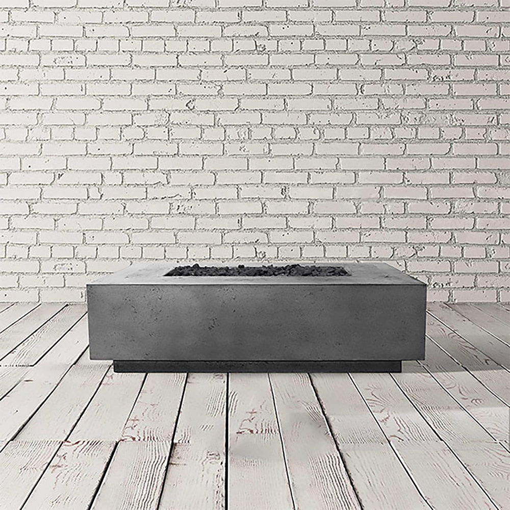 Prism Hardscapes Tavola 1 Gas Fire Pit in a natural grey finish, presented in a sleek studio setting. The rectangular fire pit offers a blend of simplicity and durability, crafted from concrete with a natural, neutral tone. Ideal for any backyard or patio, the gas-powered fire pit delivers warmth and ambiance for outdoor gatherings. Its natural grey color makes it versatile for various decor styles. 