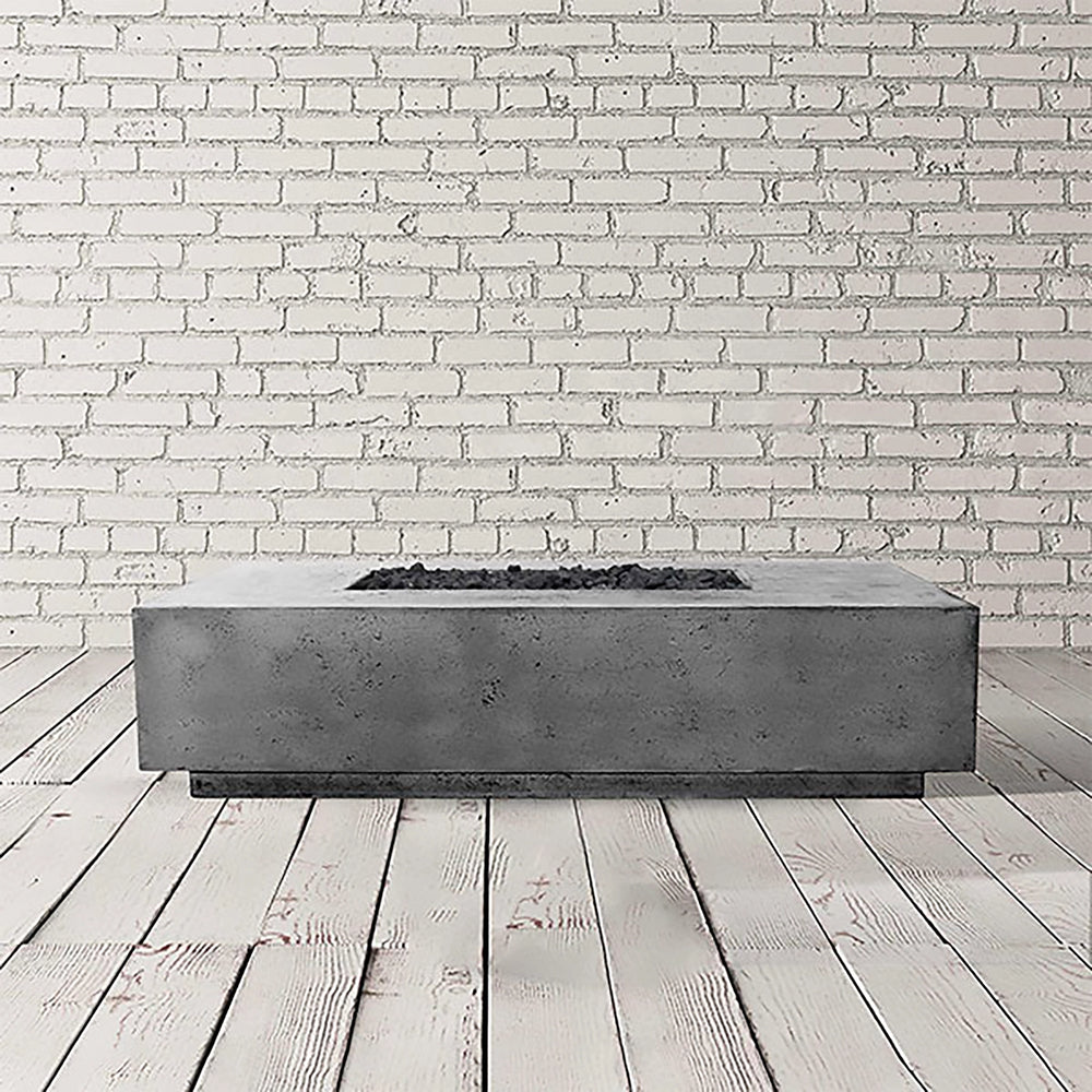 Prism Hardscapes Tavola 4 Gas Fire Pit in a sleek pewter gray finish, showcasing a sturdy and modern concrete design. This low-profile rectangular fire pit is ideal for outdoor spaces, combining functionality with contemporary style for luxury outdoor fire features and modern fire pit installations