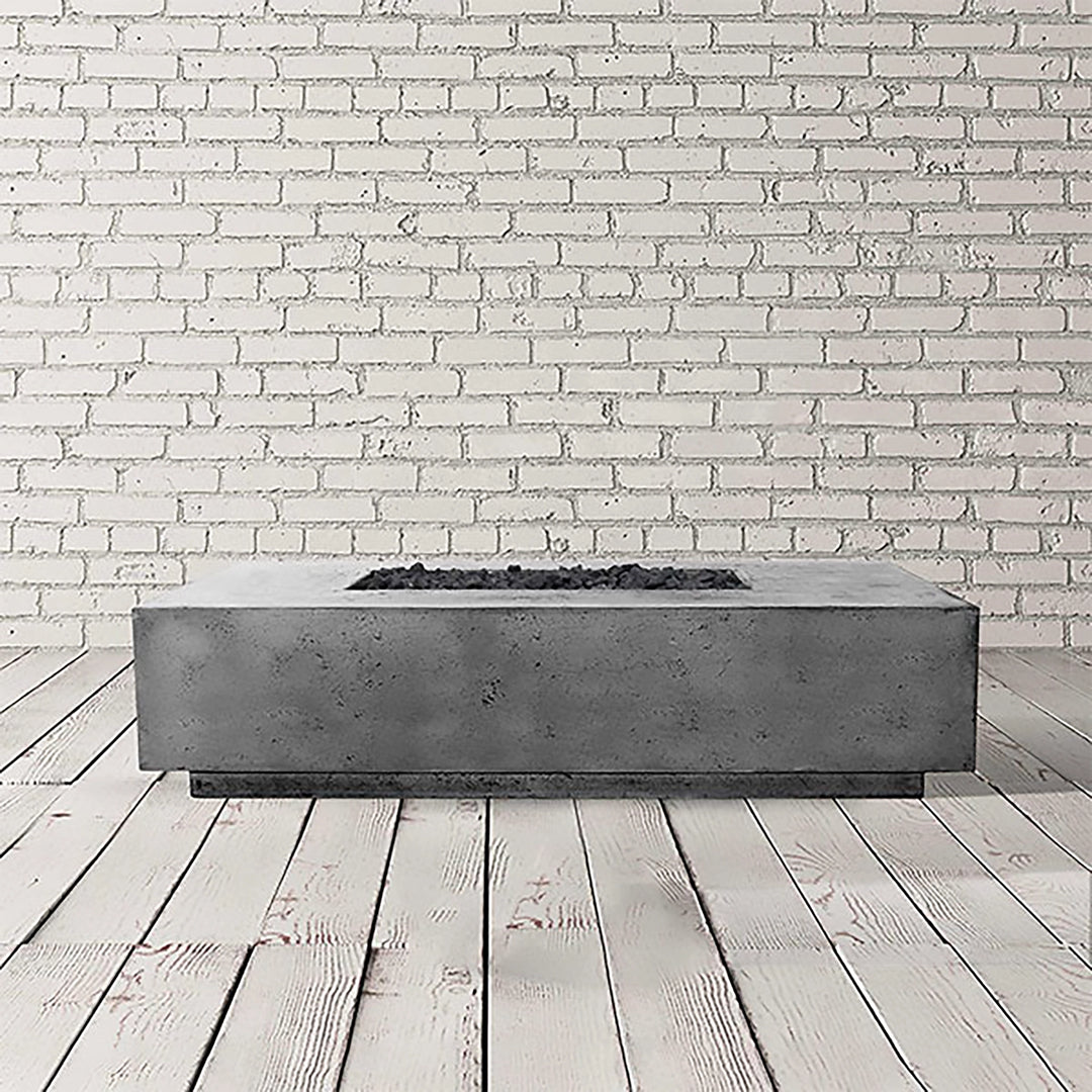 Prism Hardscapes Tavola 4 Gas Fire Pit in a sleek pewter gray finish, showcasing a sturdy and modern concrete design. This low-profile rectangular fire pit is ideal for outdoor spaces, combining functionality with contemporary style for luxury outdoor fire features and modern fire pit installations