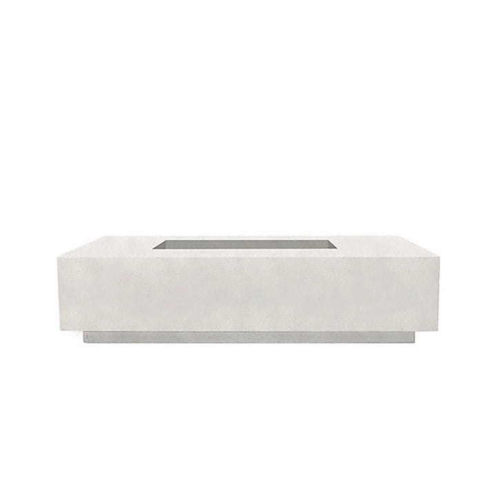 A sleek view of the Prism Hardscapes Tavola 4 gas fire pit in ultra white, emphasizing its crisp, clean lines and minimalist design. Made from durable concrete, this white fire pit is perfect for modern outdoor spaces, creating a striking contrast against natural surroundings. Ideal for contemporary patios, backyard spaces, and outdoor fire pit areas, this fire pit runs on natural gas or propane, delivering both warmth and style.