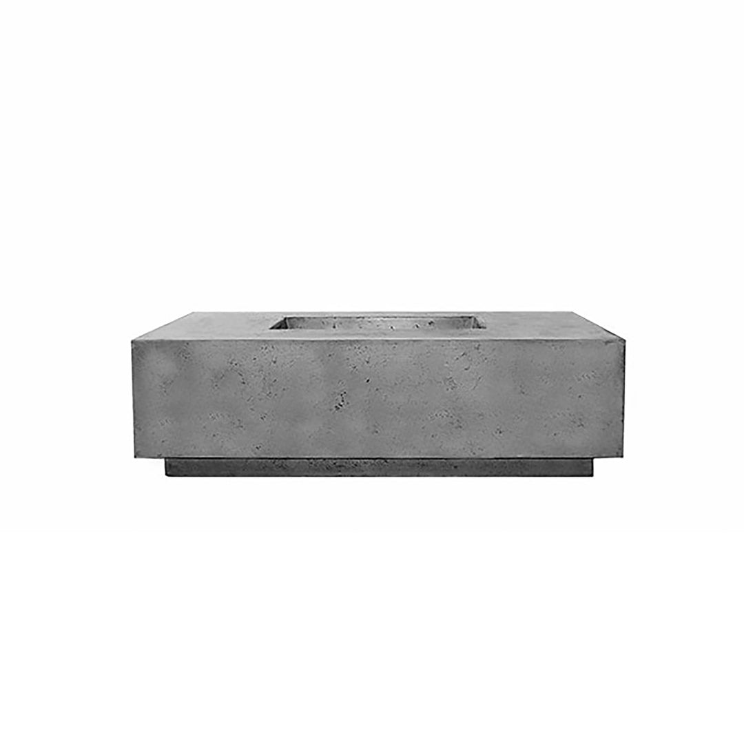 Prism Hardscapes Tavola 7 Gas Fire Pit in pewter finish, shown in an angled view highlighting its industrial-inspired design. This modern outdoor fire pit is made from durable concrete and features clean, sharp edges for a sleek look. The pewter color adds a contemporary touch, making it suitable for upscale patios and outdoor areas. Ideal for gas-fueled outdoor heating.