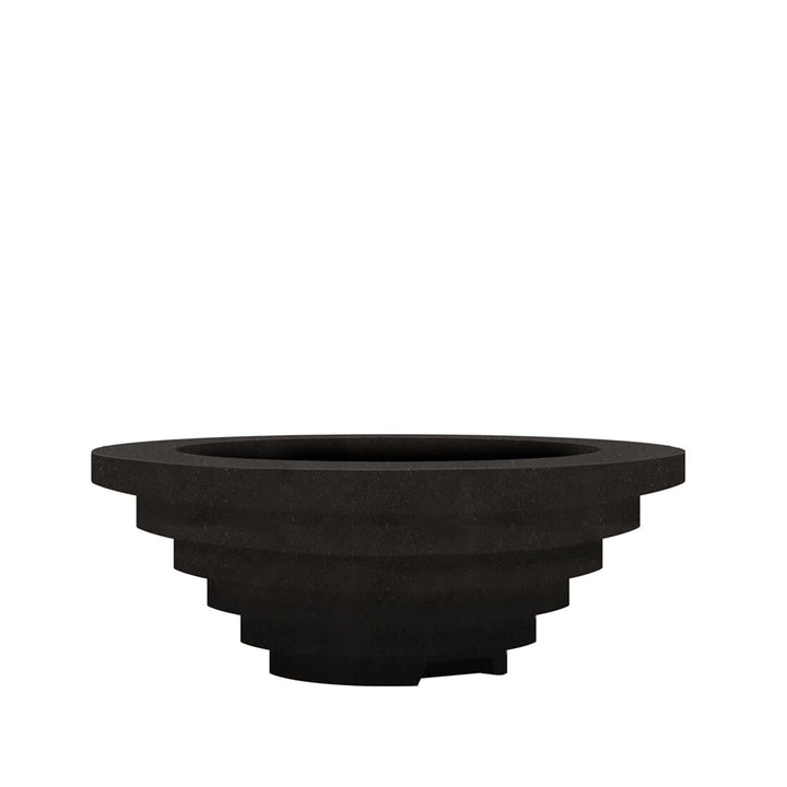 Prism Hardscapes Triton Gas Fire Pit in Ebony finish, featuring a multi-tiered stepped design in deep, modern black tones. Crafted from high-quality concrete, this round fire pit blends durability and style, making it a striking centerpiece for any patio or backyard setup. Suitable for both natural gas and propane use