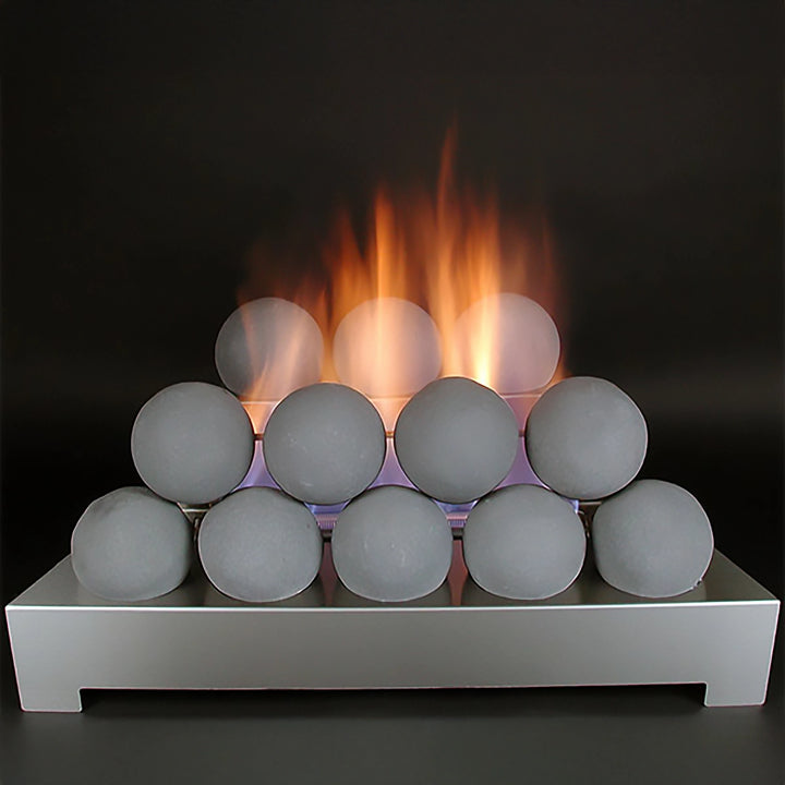 Rasmussen Alterna vent-free fireballs in light gray displayed on a sleek silver platform with a warm, natural flame glow. This lifestyle setup showcases the smooth, spherical fireballs arranged in a stack, ideal for enhancing modern indoor spaces. Vent-free design provides an eco-friendly, safe ambiance for any room. Perfect for those seeking a modern and efficient fire feature for their living area