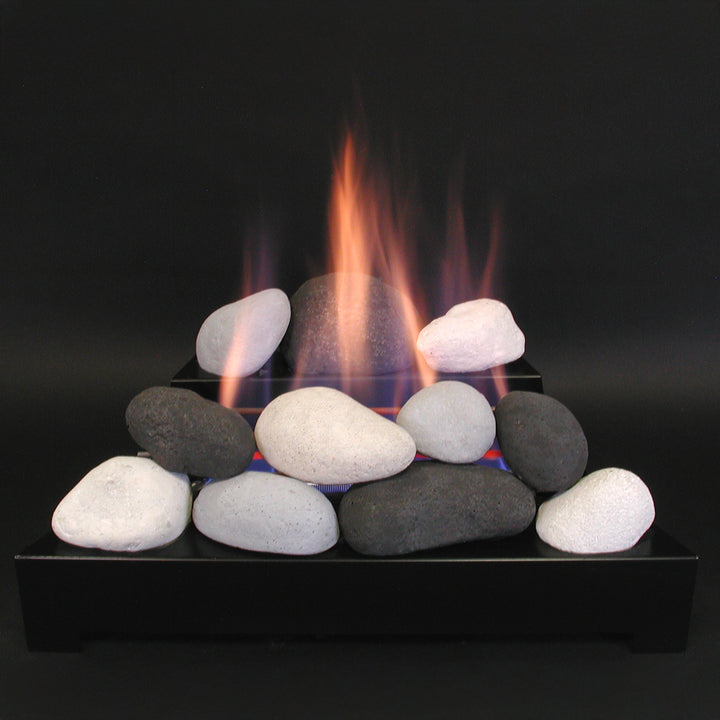 Rasmussen Alterna Vent-Free FireStones in a lifestyle display with realistic flames rising from a set of black, gray, and white stones. This setup exemplifies the elegant ambiance created by vent-free gas fireplaces, providing a warm glow perfect for indoor spaces. Ideal for natural gas or propane fireplaces, these fire stones feature a smooth, natural look that enhances the aesthetic of modern, ventless fire pit designs, making them an excellent choice for home interiors.