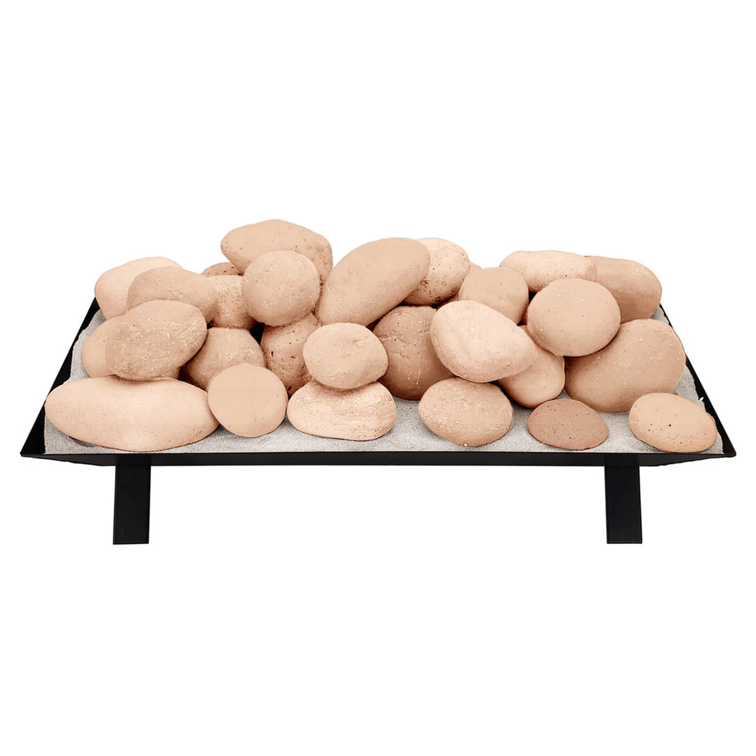 Large stack of beige Rasmussen Vented FireStones on a vented tray, showcasing a natural, smooth texture. A durable, decorative choice for outdoor gas fireplaces, adding elegance and functionality to fire pit setups.