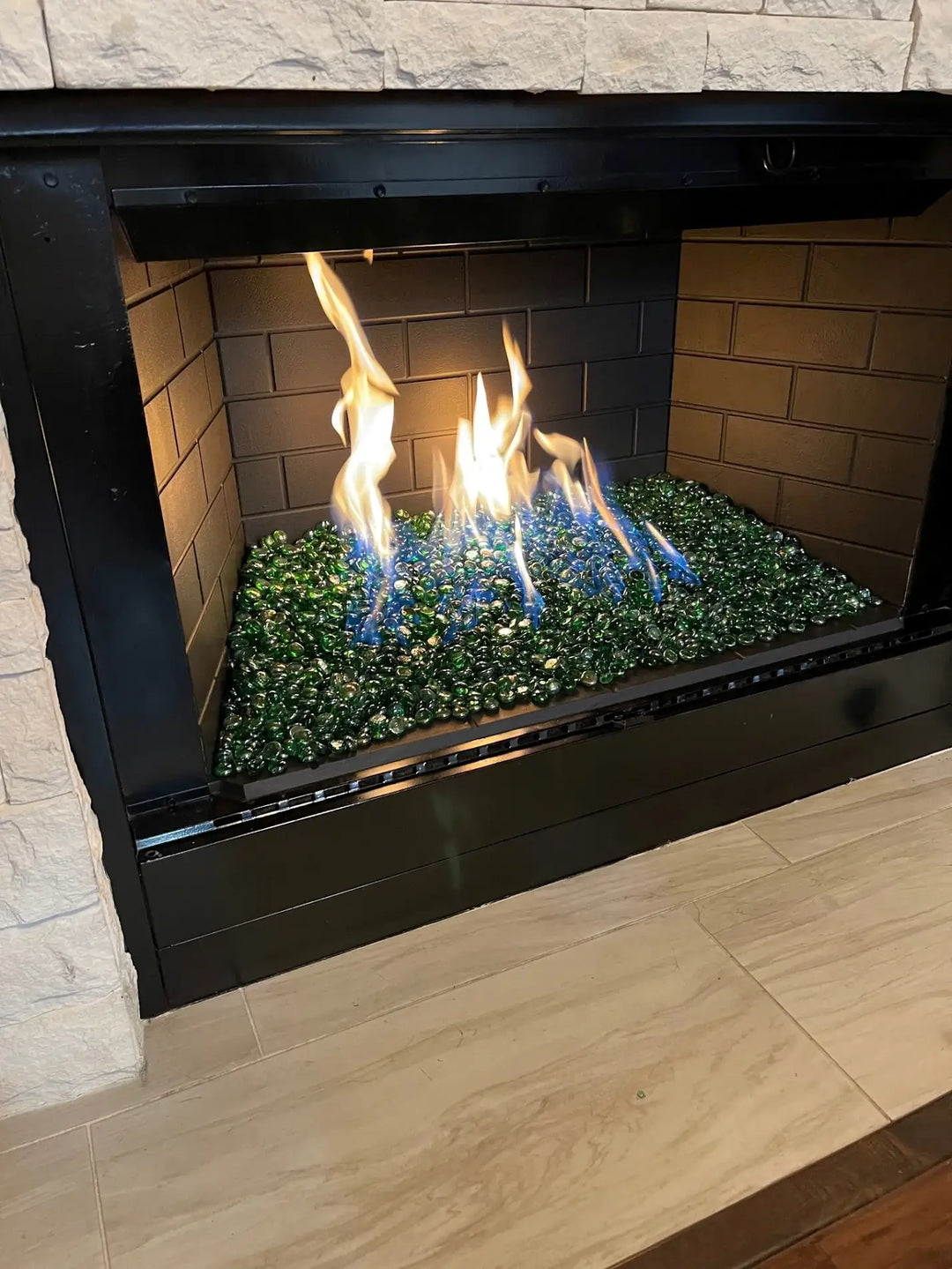 Green fire beads or drops are showcased ignited in an indoor living room