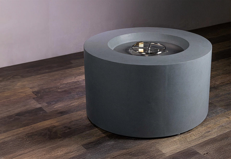 Modern round concrete fire pit with a stainless steel burner, designed for outdoor patios and contemporary backyard settings