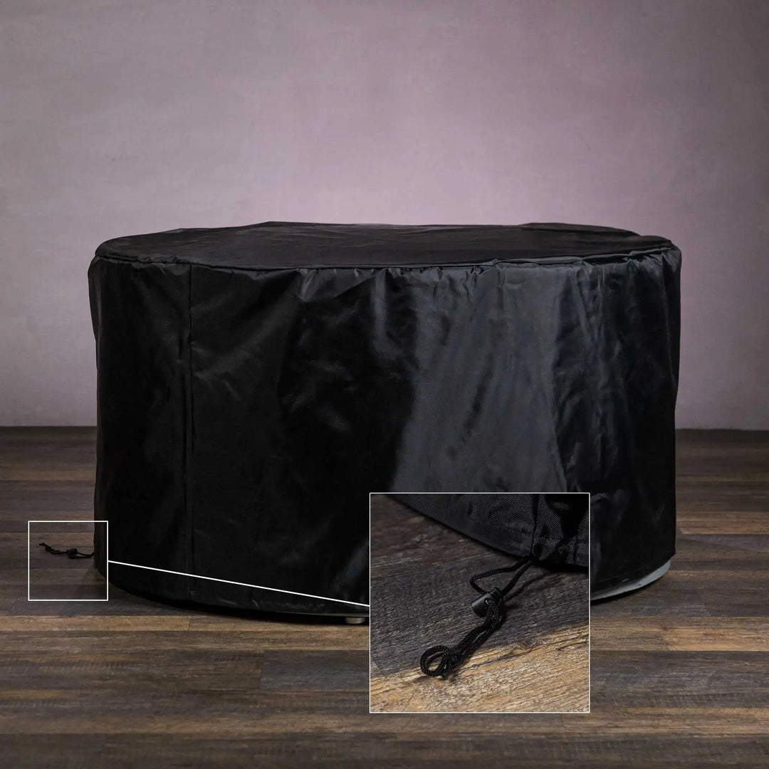 Starfire Designs round fire pit covered with a durable black protective cover featuring a secure drawstring closure, designed to protect outdoor fire pits from the elements