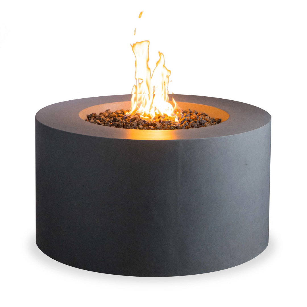 Cylindrical concrete fire pit with dark lava rocks and a burning flame, offering a sleek and modern outdoor heating option for patios or backyards