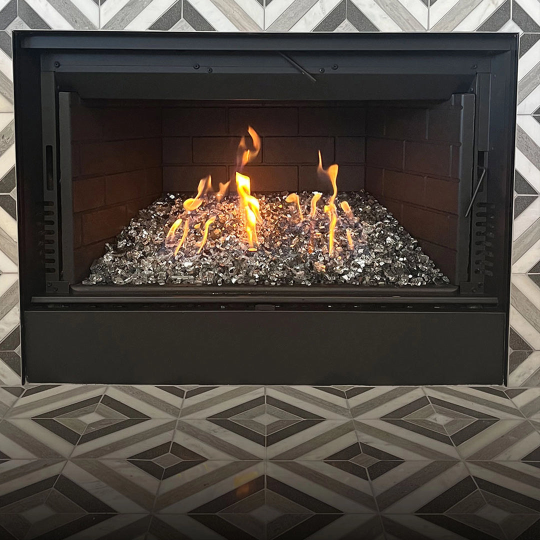 A professional applying Rutland Hi-Temp Paint Premium 1400 F Brush-On Paint inside a fireplace. The non-toxic formula provides excellent heat resistance and creates a protective black coating that is perfect for restoring and maintaining high-heat surfaces.