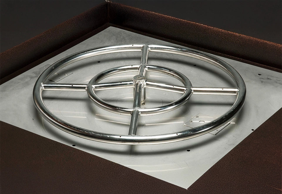 Stainless steel fire pit pan with a round gas burner, designed for even flame distribution in outdoor fire features