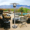 A stainless steel natural gas patio heater set in an outdoor patio area with a scenic mountain backdrop. The patio heater is positioned beside stylish outdoor furniture, providing ample heat for comfort during cool evenings. The modern design and durable construction make it ideal for upscale outdoor environments.