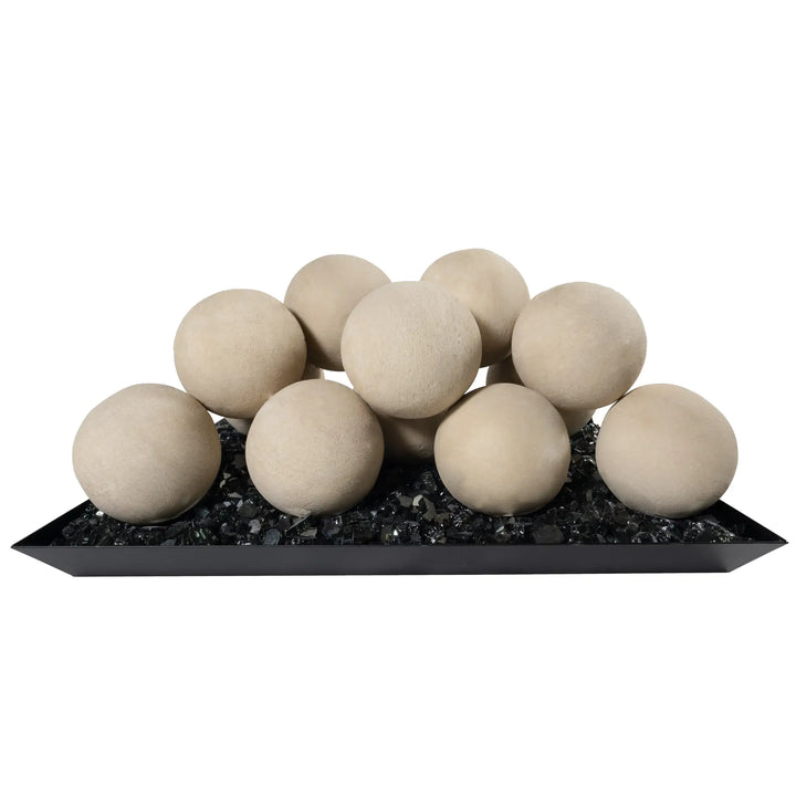 Studio image of Starfire Designs 4-inch ceramic fire balls in beige, arranged on black fire glass. The fire balls' neutral beige color contrasts against the black background, offering a minimalist, modern design. Ideal for enhancing fire pit aesthetics, these ceramic spheres are both functional and decorative, made to withstand high heat