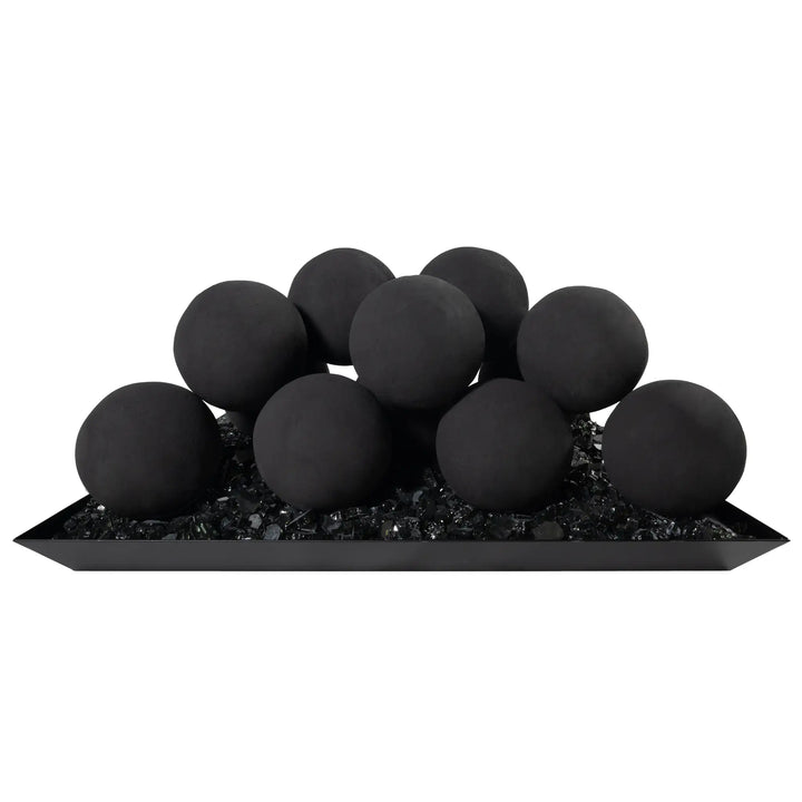 Silo view of the Starfire Designs 4-inch black ceramic fire balls, set of 12, arranged atop black reflective fire glass. The smooth, matte surface of the fire balls gives a modern and bold appearance, perfect for contemporary outdoor fire pit designs. Ideal for both residential and commercial outdoor spaces