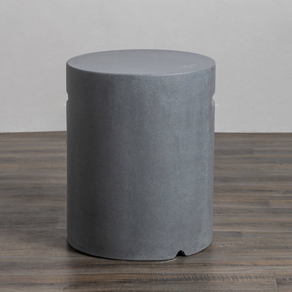 This image displays the Starfire Designs Beton 16" Natural Gray Round Propane Tank Cover from a front-facing angle, showcasing its smooth, cylindrical concrete design in natural gray. The durable material and neutral tone make it a modern, functional addition to conceal propane tanks for outdoor fire pits. Perfect for large backyard fire pits, this stylish cover blends seamlessly into various outdoor settings.