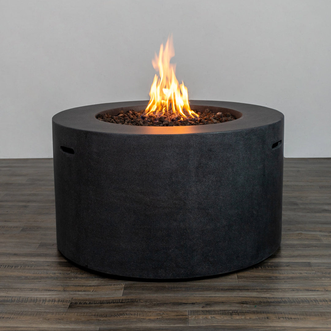 Starfire Designs Beton 42-inch Graphite Round Concrete Gas Fire Pit with an active flame, showcasing the warm ambiance created by the vibrant fire set against the contemporary graphite finish.