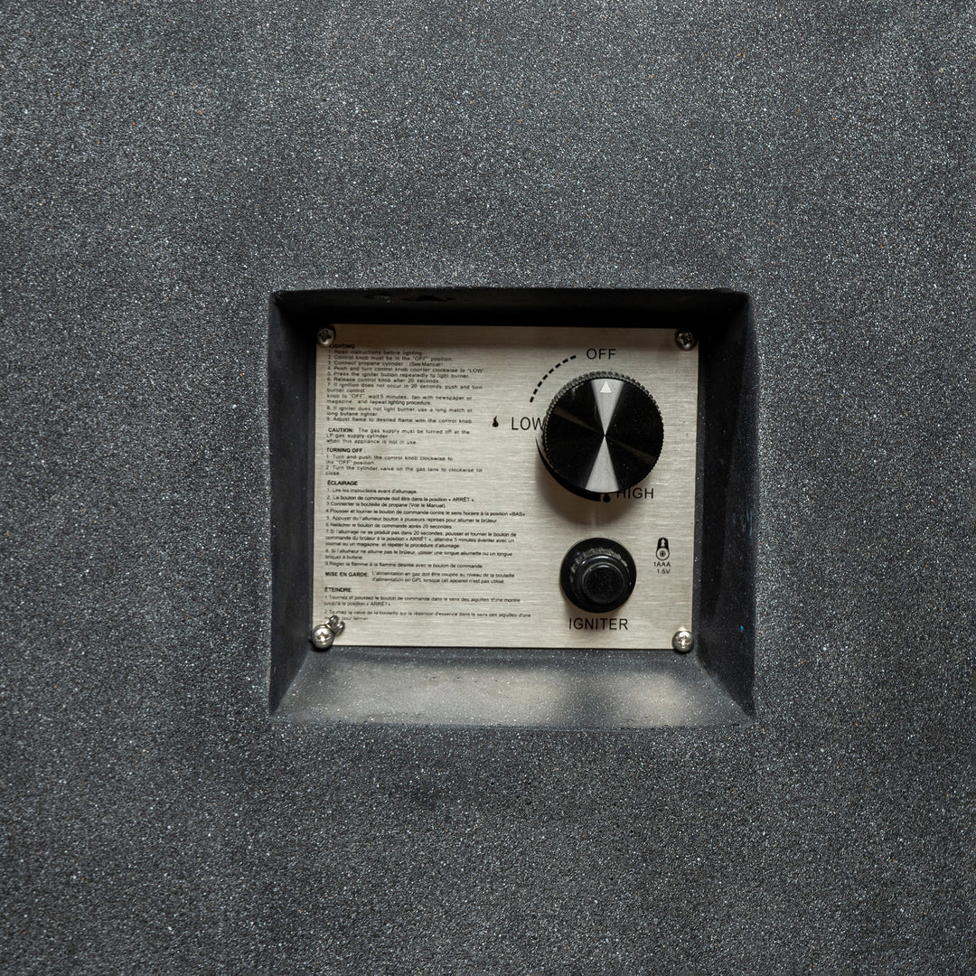 Detailed view of the Starfire Designs Beton 42-inch Graphite Gas Fire Pit's ignition control panel, featuring an easy-to-use dial for flame adjustment and an electronic igniter. The panel is recessed into the concrete surface for a clean, modern look.