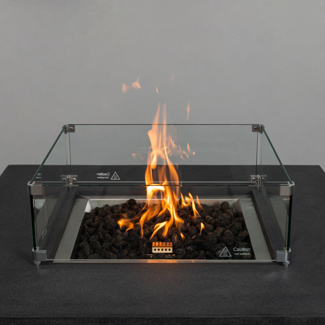 Close-up of the flames inside the Starfire Designs Beton 42" Graphite Fire Pit, with the glass wind guard enhancing safety and style. The perfect addition to outdoor spaces.