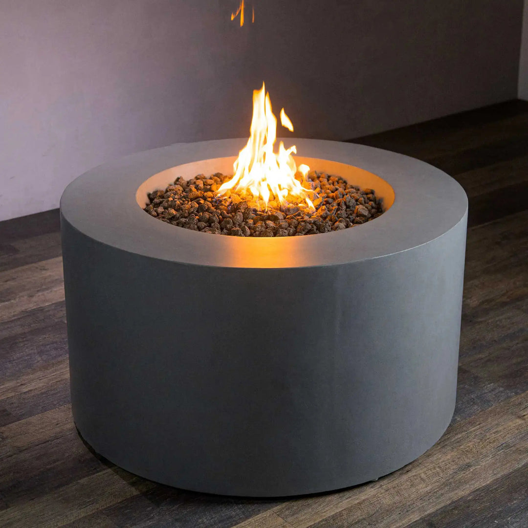 Starfire Designs Beton 42-inch Round Gas Fire Pit in Natural Gray with Hidden Propane Tank, showcasing a modern circular design with a vibrant flame over lava rocks