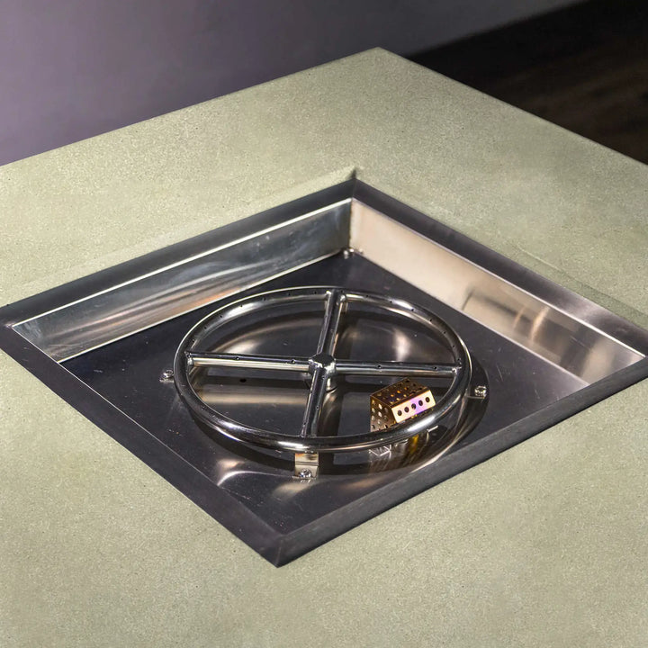 Detailed shot of the stainless steel burner pan inside the Starfire Designs Beton 42-inch square hidden propane tank fire pit, designed for efficient heat distribution and long-lasting performance