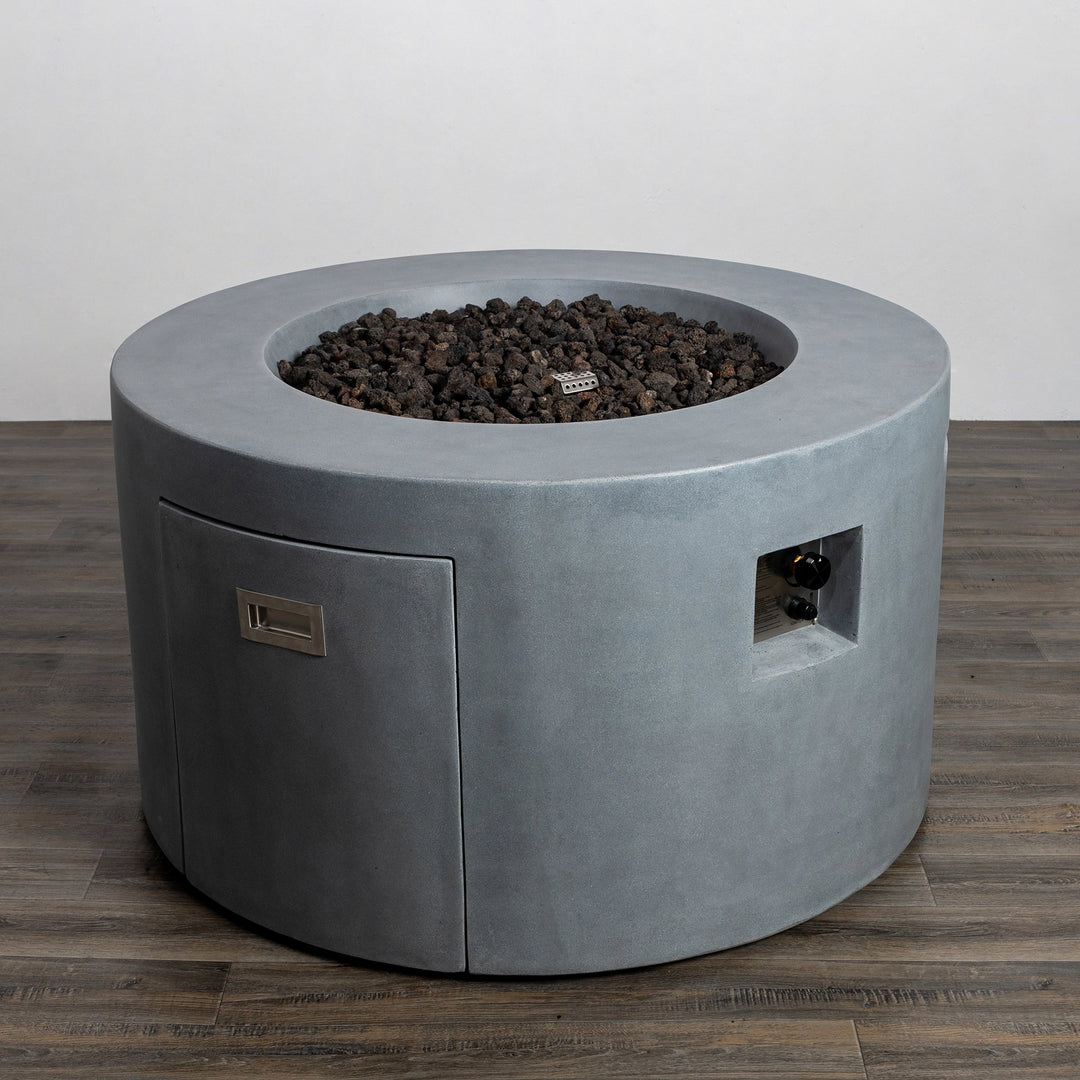 A top-down view of the Starfire Designs Beton 42" Natural Gray Round Concrete Gas Fire Pit showcasing the bed of dark lava rocks filling the fire pit basin, designed for efficient heat distribution and a natural outdoor aesthetic.