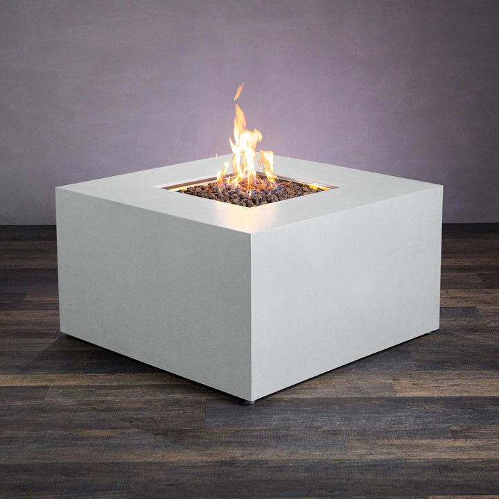 Front view of the Starfire Designs Beton 42-inch white square gas fire pit. This modern fire pit features a clean, white concrete body with a hidden propane tank compartment. The square design highlights a centered flame surrounded by natural lava rocks, perfect for enhancing outdoor ambiance. Ideal for luxury backyard settings and patio use