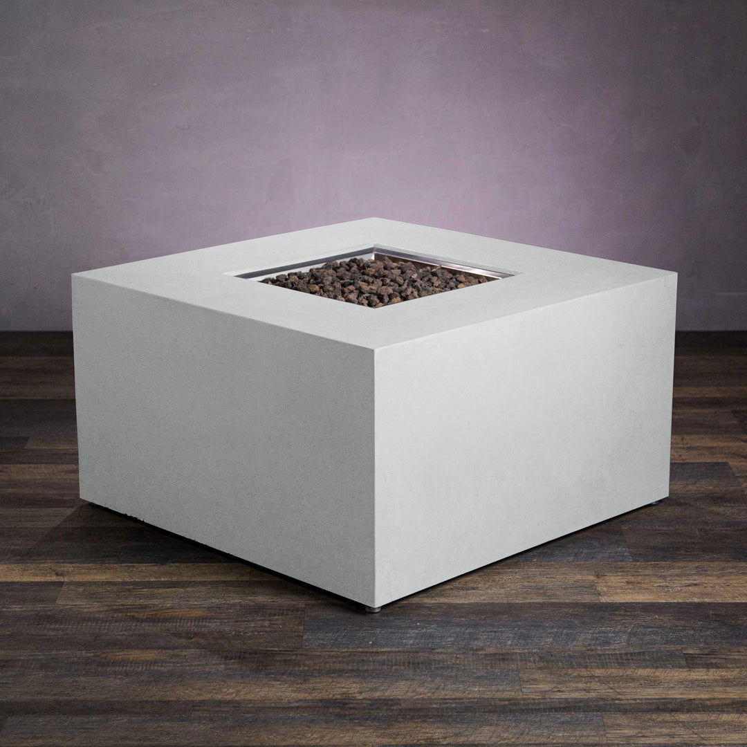 Starfire Designs Beton 42-inch white square gas fire pit without flames. This contemporary outdoor fire pit showcases a large, smooth white concrete frame with a recessed center for lava rocks and a hidden propane tank for sleek functionality. Perfect for modern outdoor living spaces and patios