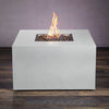 Side view of the Starfire Designs Beton 42-inch white square concrete gas fire pit with hidden propane tank access. The sleek, minimalist design features durable concrete construction, with flames rising from the center filled with black lava rocks. A perfect outdoor fire pit for backyard, patio, or commercial spaces