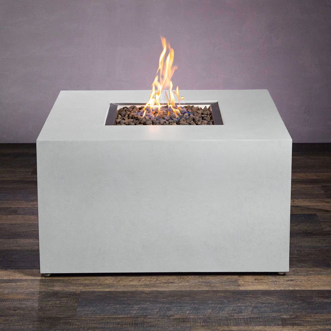 The Starfire Designs Beton 42" White Square Hidden Propane Tank Gas Fire Pit in a side-angle shot, highlighting its modern geometric design and built-in portability handles. 