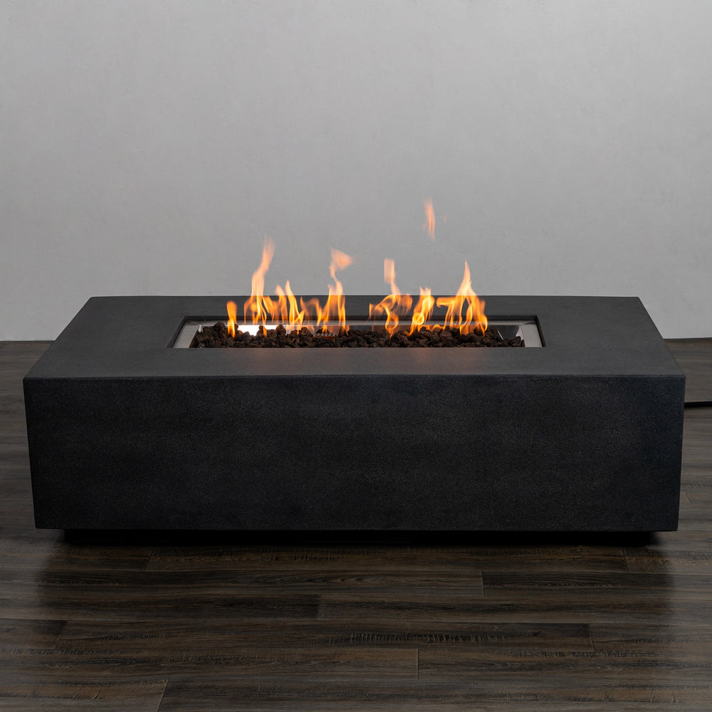 The Starfire Designs Beton 55" Graphite Rectangle Gas Fire Pit fully lit with vibrant, dancing flames, creating a cozy and contemporary ambiance for any backyard or patio setting.