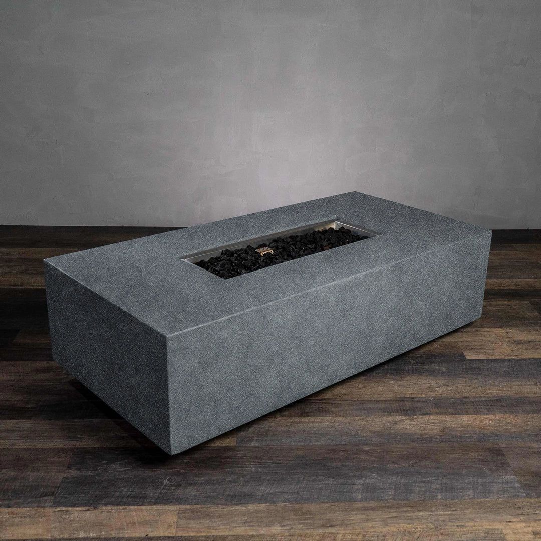  This image highlights the Starfire Designs Beton 55" Graphite Rectangle Gas Fire Pit with an empty firebox, ready for lava rock or fire glass installation. The durable graphite concrete body is designed for outdoor durability and adds a modern touch to any space. The sleek design accommodates a wide flame distribution for maximum warmth. 