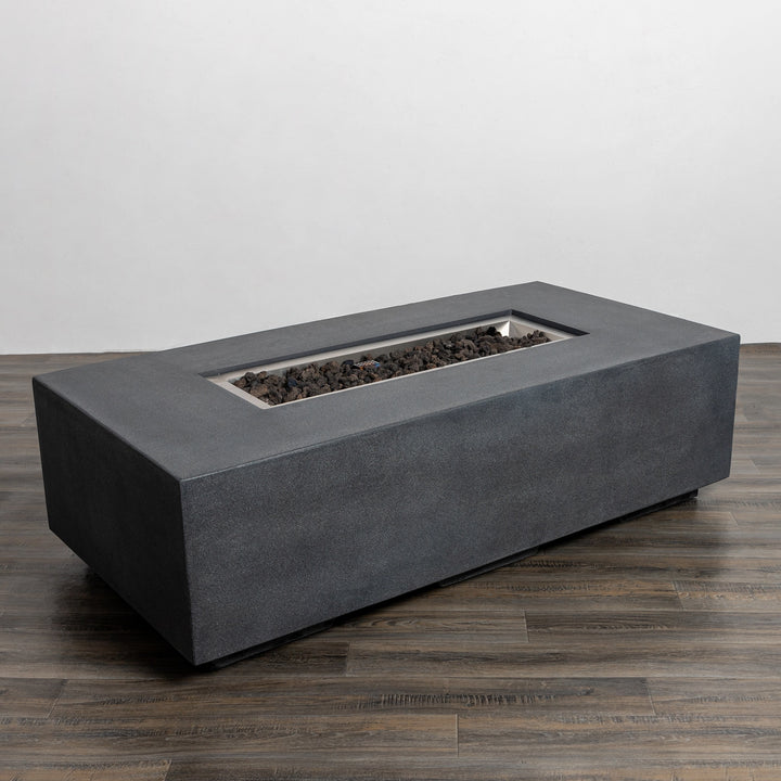 Top-down view of the Starfire Designs Beton 55" Graphite Rectangle Gas Fire Pit in an unlit state, displaying the spacious burner area filled with decorative lava rocks for a clean, contemporary appearance.