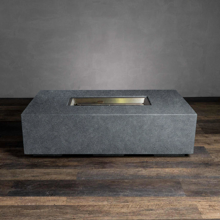 The Starfire Designs Beton 55" Graphite Rectangle Gas Fire Pit is displayed without the flame, showcasing its minimalist and robust construction. The firebox is built to support lava rock media or other fire glass materials, and the steel burner is tucked into the graphite-colored concrete body. Perfect for contemporary outdoor spaces.