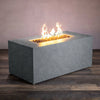 Angled view of the Starfire Designs Beton 55" Graphite Rectangle Hidden Propane Tank Gas Fire Pit, showcasing the modern concrete design with a smooth graphite finish and a robust flame in the rectangular burner filled with lava rock. Perfect for outdoor spaces, this gas fire pit offers both functionality and style with its hidden propane tank feature